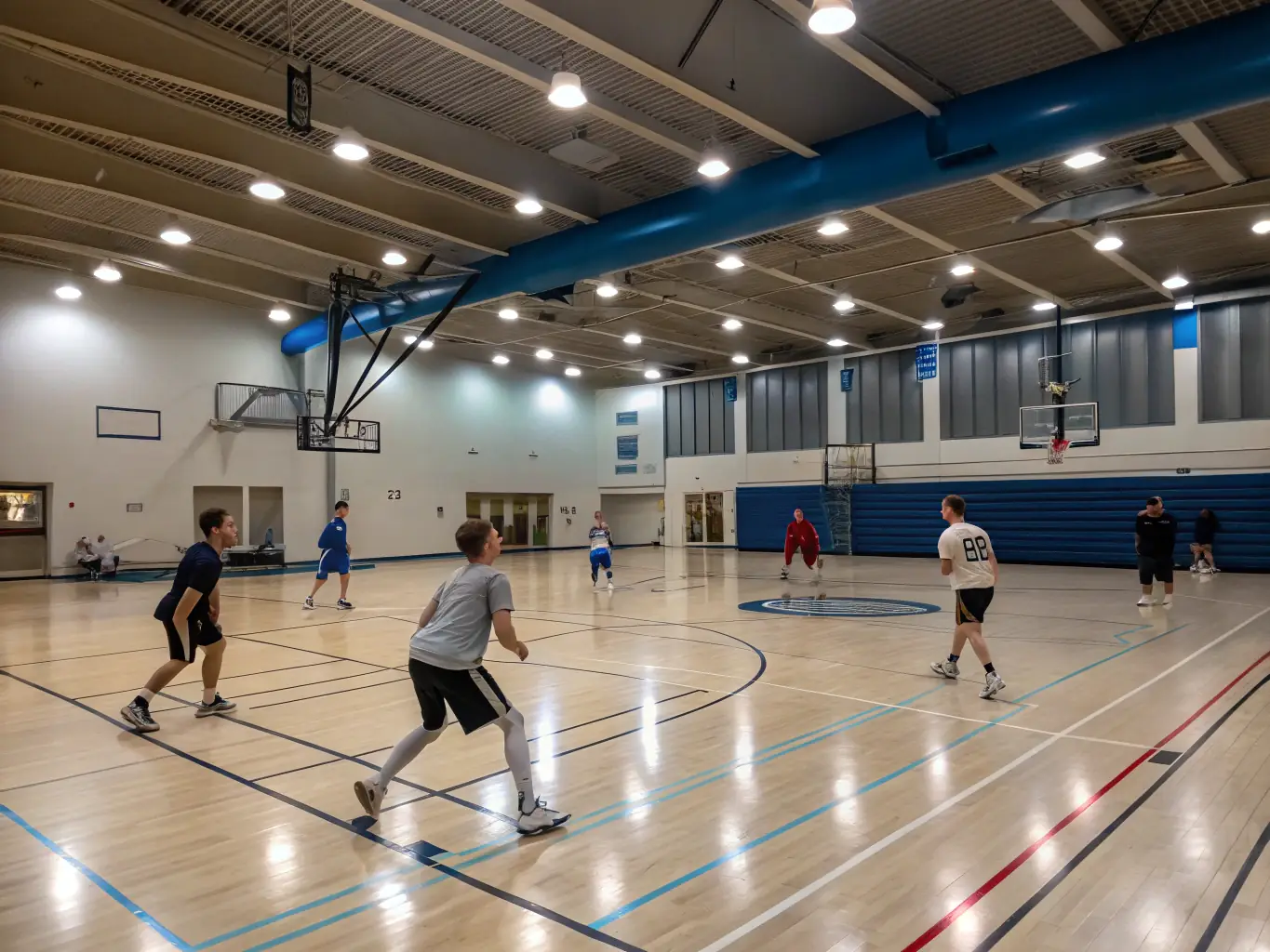A dynamic action shot of students playing basketball in the school gymnasium, showcasing teamwork and sportsmanship.